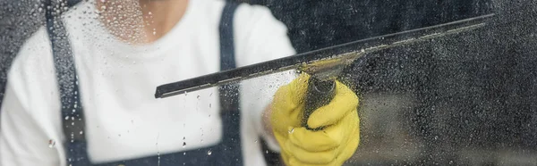 Cropped view of professional cleaner washing window in office, banner — Stock Photo