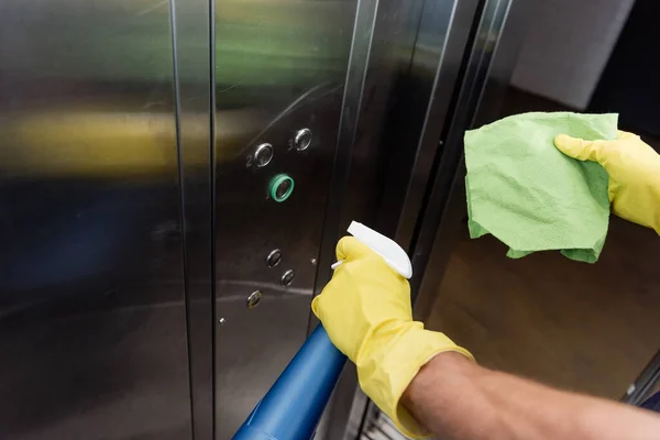 High angle view of cropped cleaner washing elevator with rag and detergent — Stock Photo