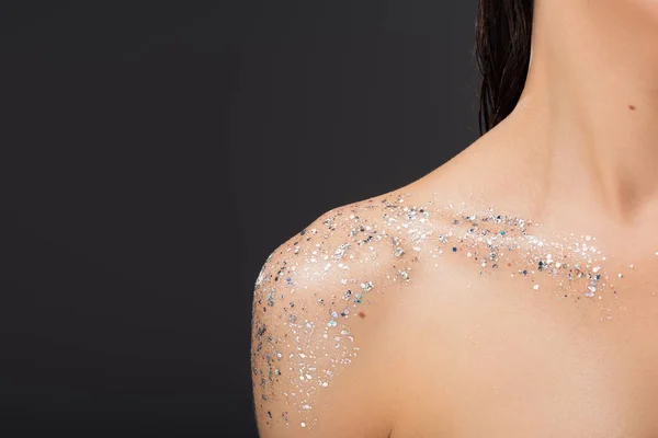 Cropped view of young woman with sparkling glitter on clavicle and bare shoulder isolated on grey — Stock Photo