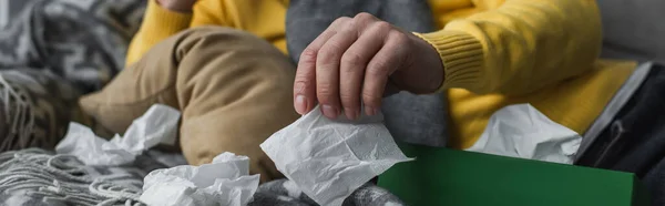 Partial view of sick man lying near crumpled paper napkins, banner — Stock Photo