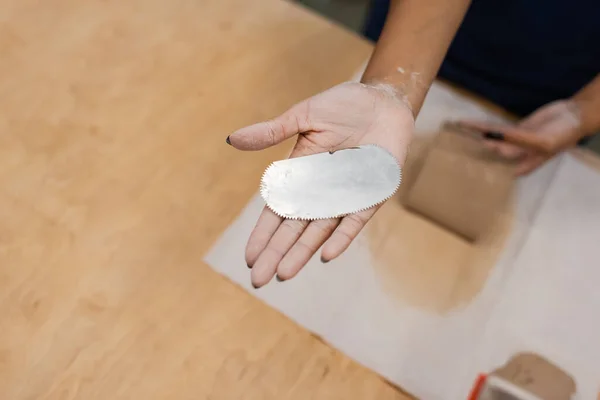 Top view of african american woman holding steel scraper in pottery workshop — Stock Photo