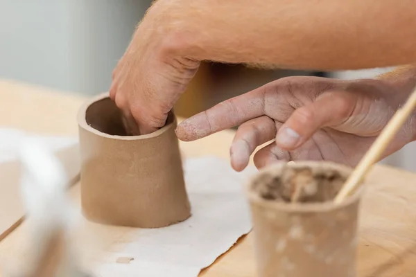 Partial view man shaping clay into cup in pottery workshop — Stock Photo