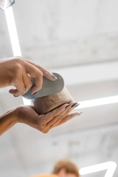 Vue à angle bas du sculpteur afro-américain fabriquant des produits en argile en atelier — Photo de stock