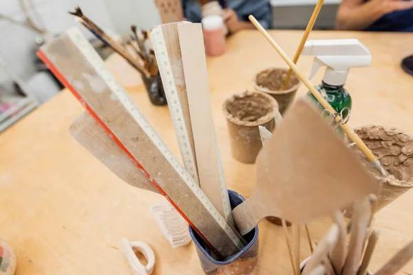 Rulers and tools on table in pottery studio — Stock Photo