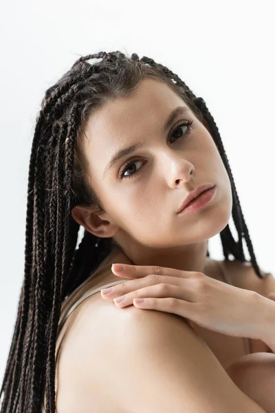 Portrait of young woman with braids  hairstyle looking at camera isolated on grey — Stock Photo