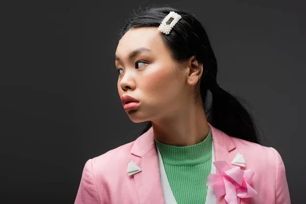 Curious asian model in jacket looking away isolated on grey — Stock Photo