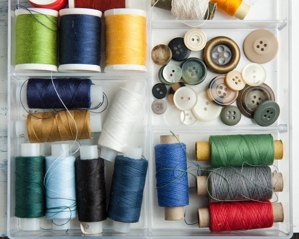 Spools of threads and buttons — Stock Photo, Image