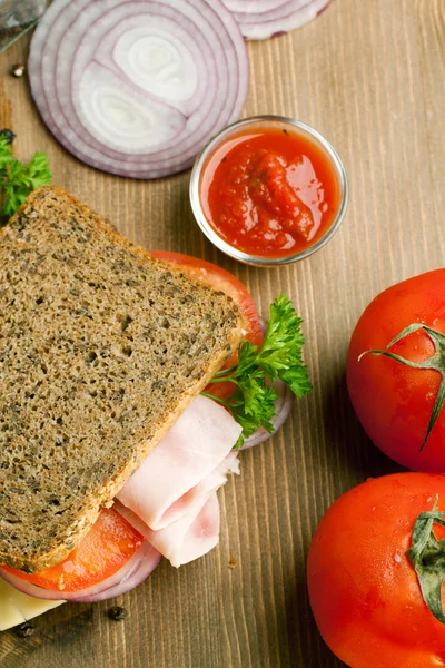 Sanduíche fresco com presunto, cebola e tomate — Fotografia de Stock