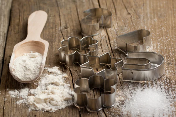Dough, sugar and cookie cutters — Stock Photo, Image