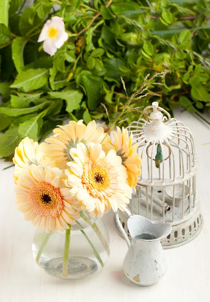 Bunch of gerbera flower with old vintage cage — Stock Photo, Image