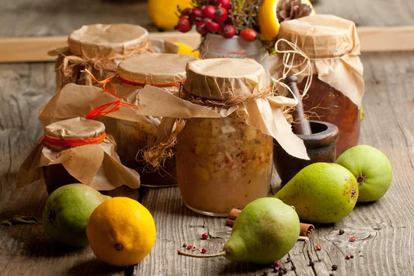 Homemade jam in glass jars on old wooden table — Stock Photo, Image