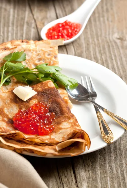 Red caviar on pancakes — Stock Photo, Image