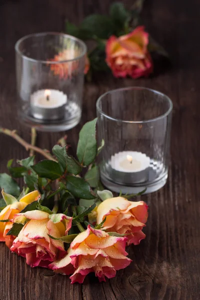 Orange roses with lightning candle — Stock Photo, Image