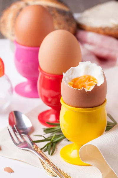 Boiled eggs, rosemary and silverware — Stock Photo, Image