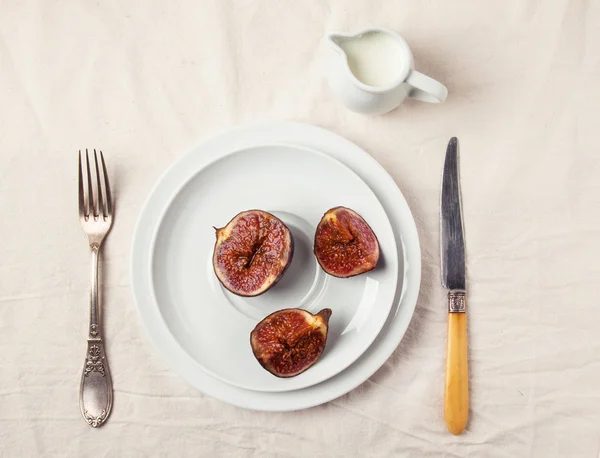 Figs and honey on white plate Royalty Free Stock Photos
