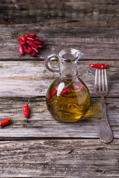 Olive oil with chili peppers — Stock Photo, Image