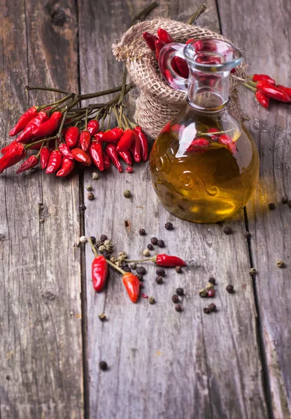Olive oil with chili peppers — Stock Photo, Image