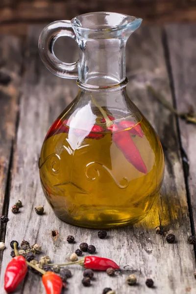 Olive oil with chili peppers — Stock Photo, Image