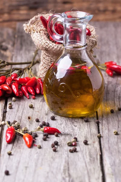 Olive oil with chili peppers — Stock Photo, Image