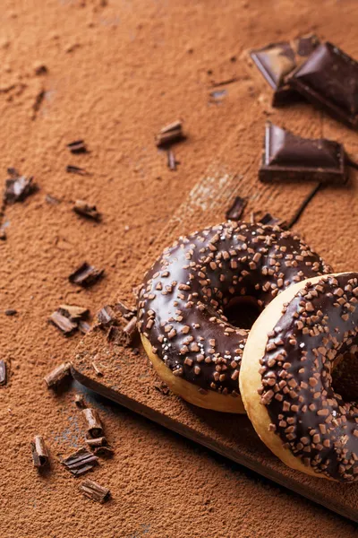 Donuts with cocoa powder and chocolate — Stock Photo, Image