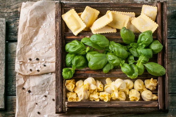 Box of pasta ravioli and basil — Stock Photo, Image