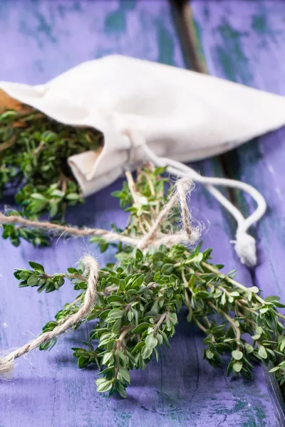 Thyme on violet wooden table — Stock Photo, Image