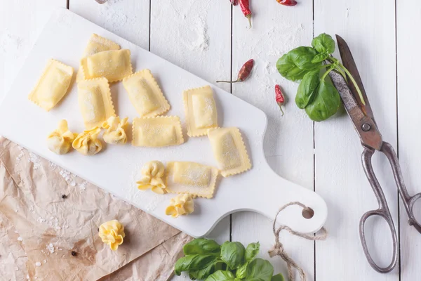 Pasta ravioli on flour with basil — Stock Photo, Image