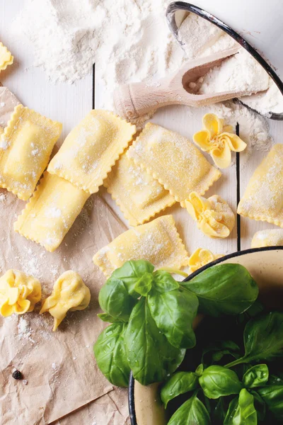 Pasta ravioli on flour with basil — Stock Photo, Image