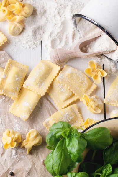 Pasta ravioli on flour with basil — Stock Photo, Image