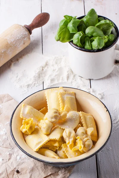 Pasta ravioli with flour and basil — Stock Photo, Image