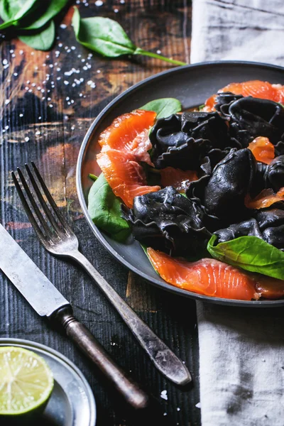 Black ravioli with salted salmon — Stock Photo, Image