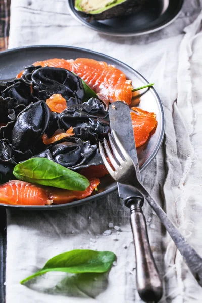 Black ravioli with salted salmon — Stock Photo, Image