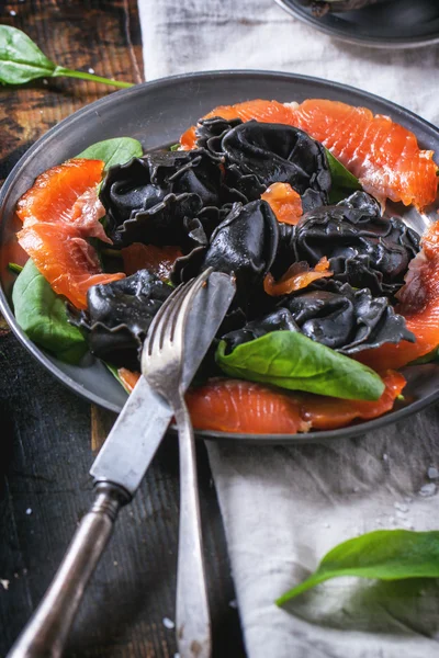 Black ravioli with salted salmon — Stock Photo, Image