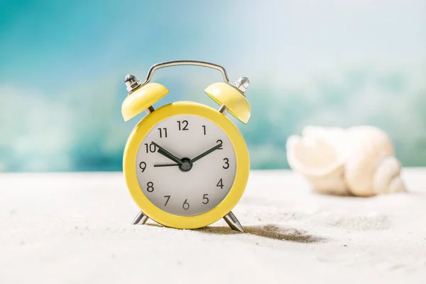 Yellow Alarm Clock Summer Sand Sea Beach Waves Seashells Background — Stock Photo, Image
