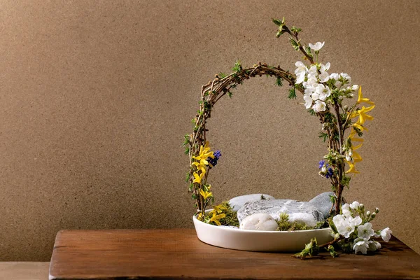 春天Ikebana 花形拱形构图 春花盛开 枝条和石头镶嵌在白色陶瓷碗中 屹立在褐色木桌上 日本风格的家居装饰 复制空间 — 图库照片