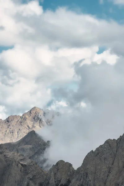 Vertical landscape of clouds between mountain ridges