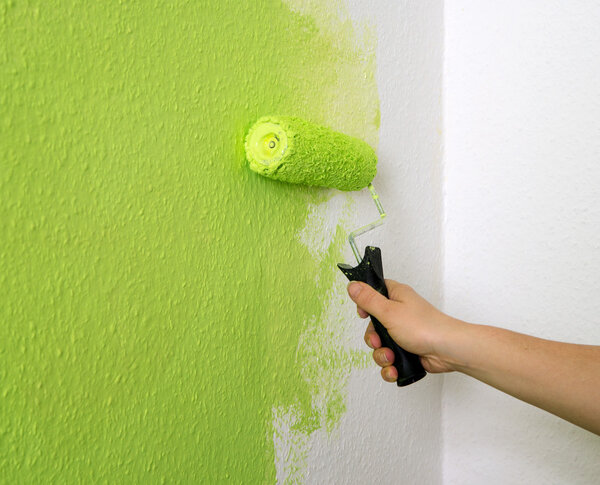 Женщина рисует стену