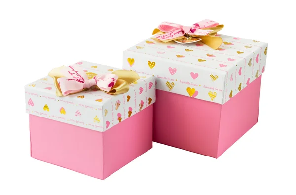 Две розовые подарочные коробки с золотыми и розовыми бантами — стоковое фото