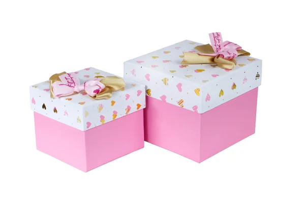 Twee roze geschenkdozen met gouden en roze bogen — Stockfoto