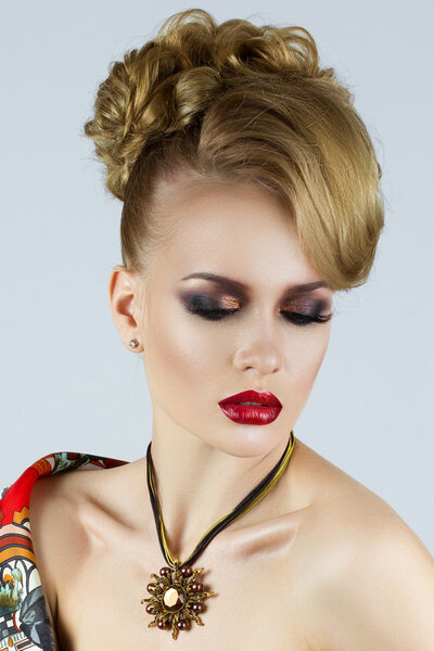 Portrait of young beautiful blonde woman with red lips