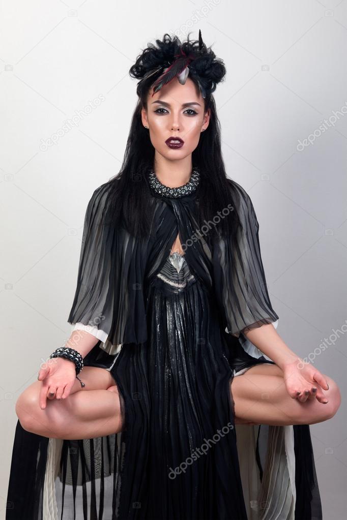 Woman shaman levitating over grey background