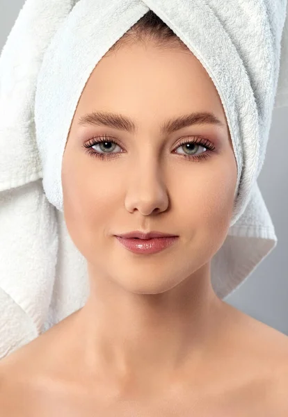 Portrait of young woman with towel on her hair — Stock Photo, Image