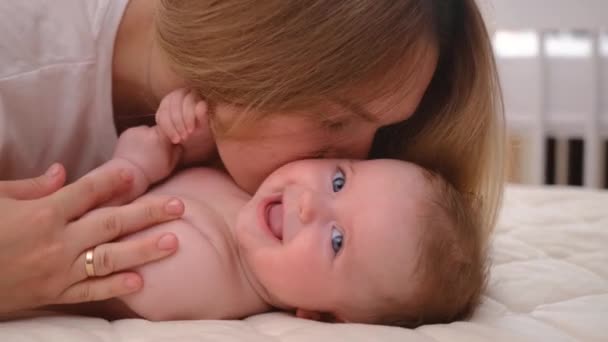 Close Mother Gently Kissing Baby Enjoying Loving Mom Playfully Caring — стоковое видео