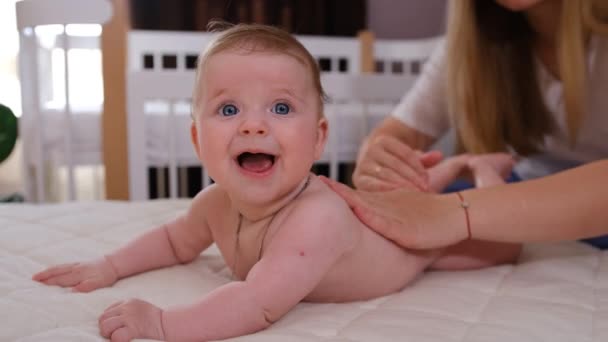 Mother Applies Cream Body Newborn Baby Child Lying Bed Looks — Wideo stockowe