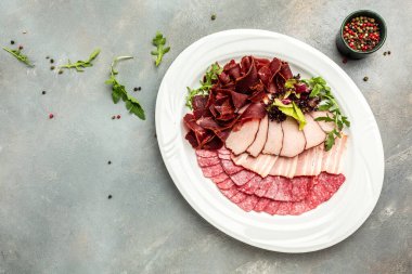 Farklı lezzetlerde tütsülenmiş sosis dilimleri. Seçmeli et tabağı. afiş, menü, metin için tarif yeri, üst görünüm.