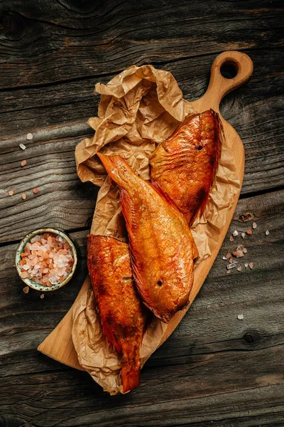 Hot Smoked River Bass Fish Wooden Cutting Board Vertical Image — Stock Photo, Image