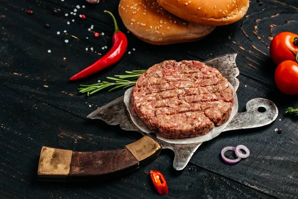 minced meat for burger, beef lamb meat Burger steak on dark wooden background with meat cleaver. top view,