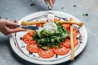Domatesli salata ve taze roka ve yeşil pesto ile Burrata peyniri..