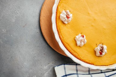 Homemade pastry pumpkin cheesecake, Pumpkin Pie with whipped cream for Thanksgiving Day. banner, menu, recipe place for text, top view.