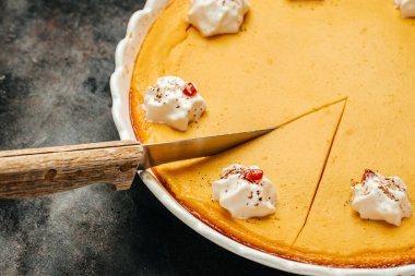 pumpkin pie with whipped cream. Homemade pastry for Thanksgiving traditional Pumpkin Pie. Food recipe background. Close up.